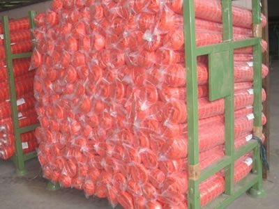 Orange plastic fence are packed in pallets.