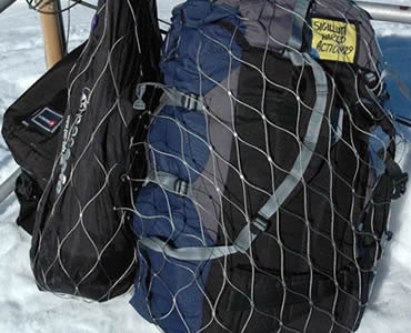 Two backpacks are put in anti-theft bags which is fixed on a stick.